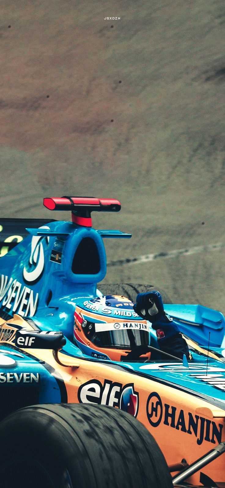 a blue race car driving on a track