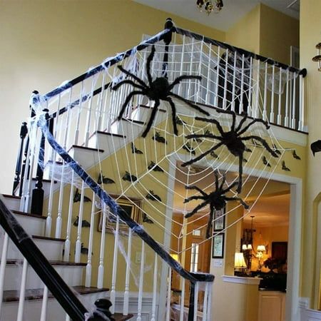 a staircase decorated with halloween decorations and spider webs