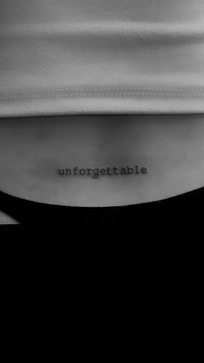 the word unforgettable is written on someone's lower back ribcage