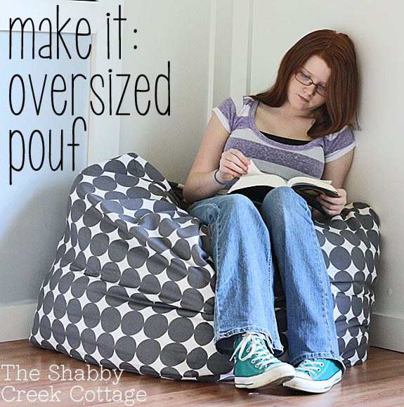 a woman sitting on a bean bag chair reading a book with the words make it oversized pouf