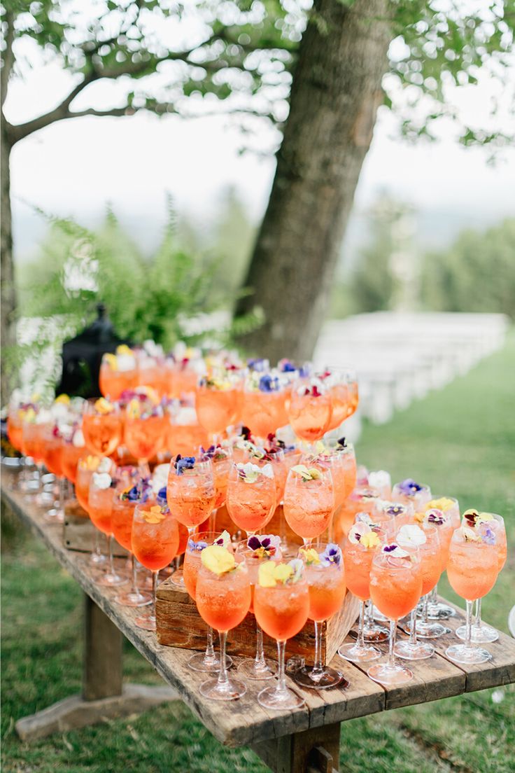 a table with glasses filled with drinks on top of it and the words style me pretty