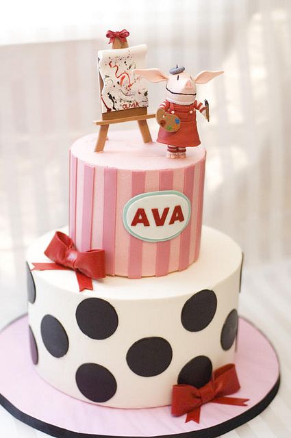 a pink and black polka dot cake with an animal on top that says ava above it