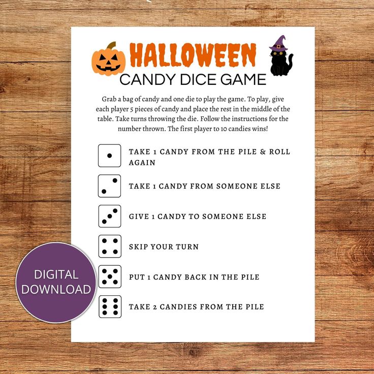 the halloween candy dice game is shown on a wooden table