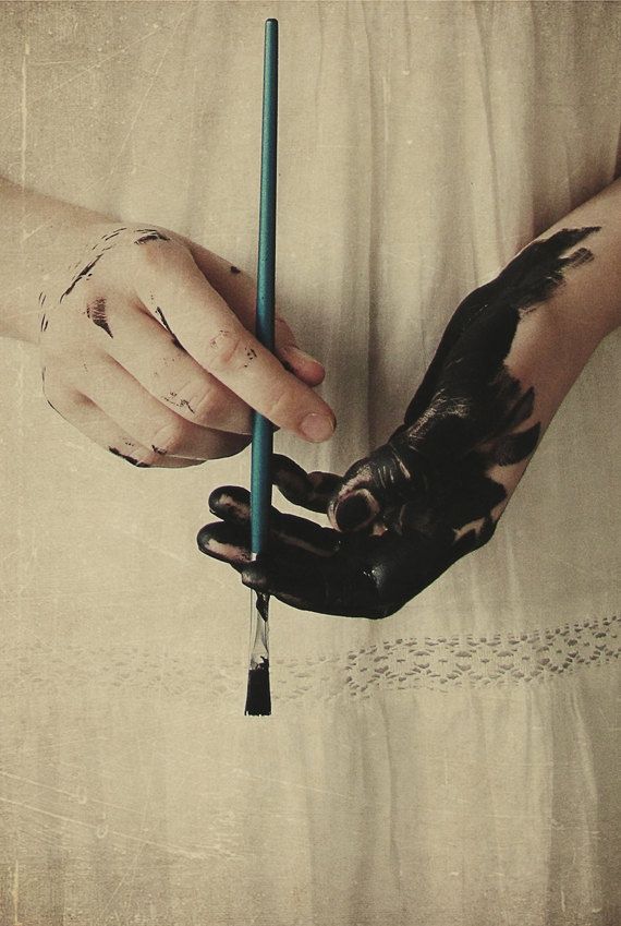 a person holding a candle in their hand with a bird on it's arm