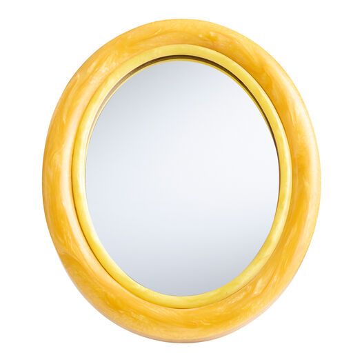 a yellow round mirror on a white background