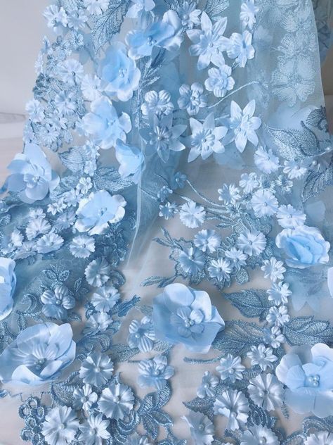 blue flowers and leaves are on the sheered fabric that is being used as a dress