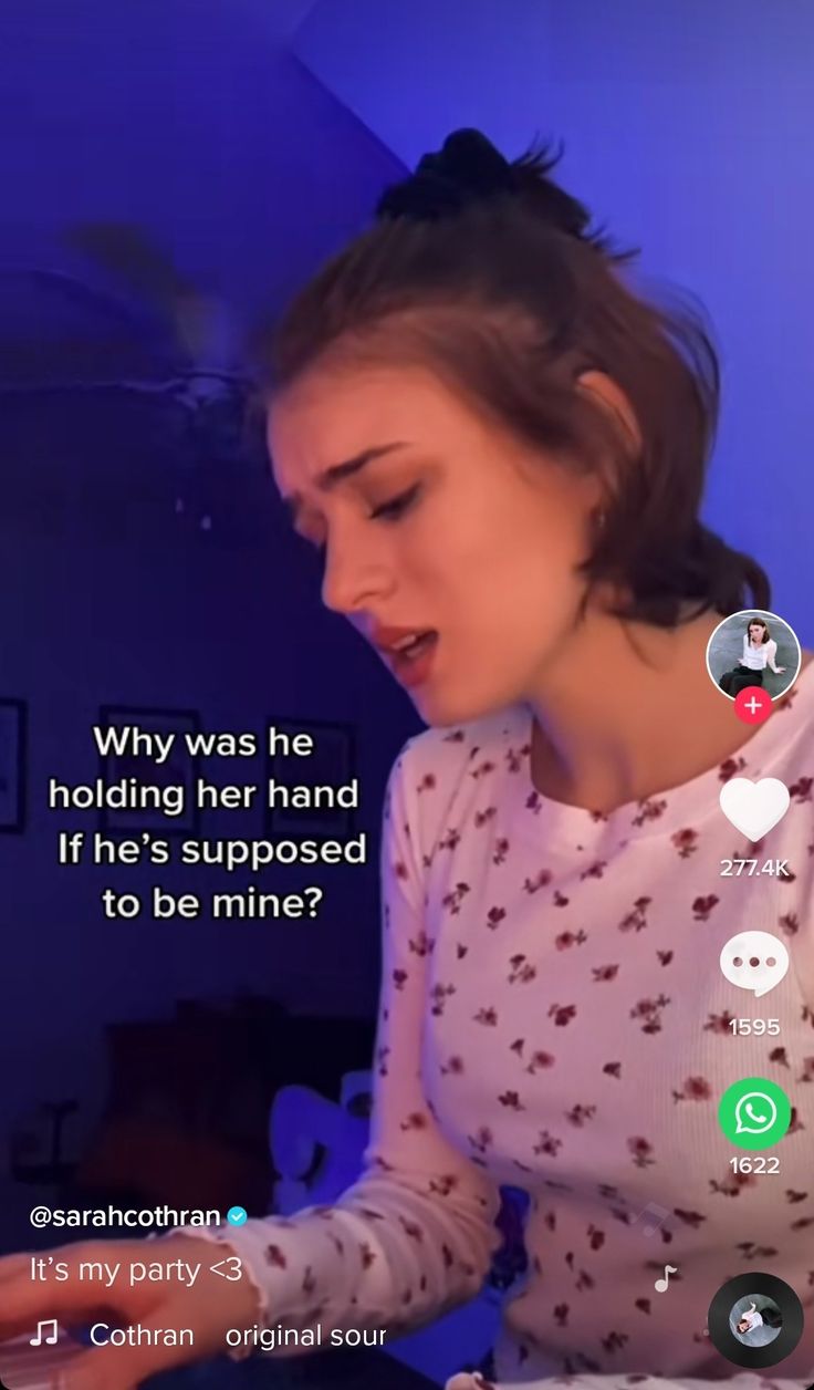 a woman sitting at a table with a cell phone in front of her and the caption, why was he holding her hand if he's supposed to be mine?