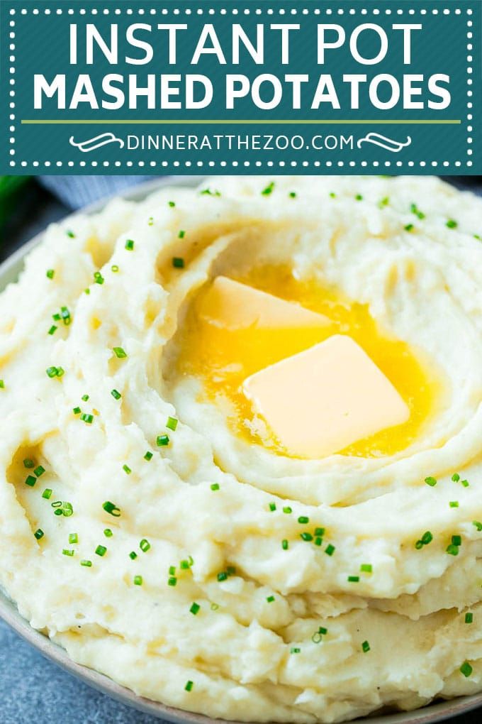 mashed potatoes in a bowl with butter and parsley on top