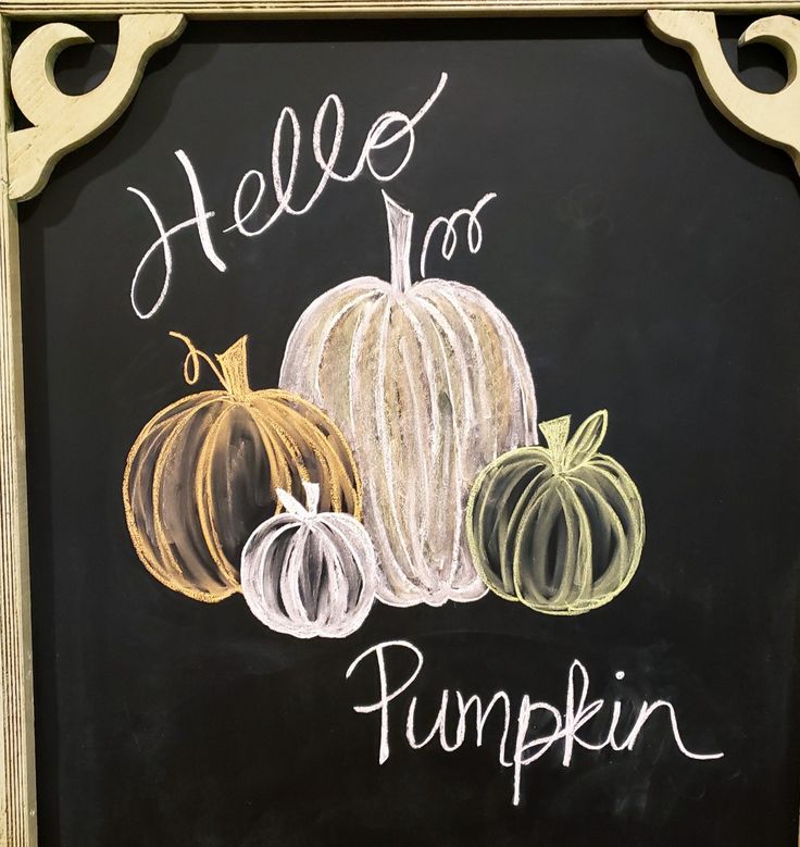 a chalk board with pumpkins painted on it