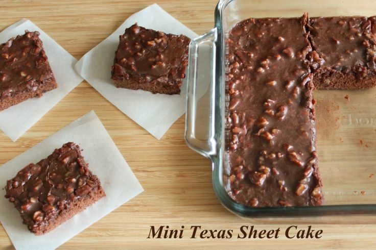 four pieces of brownie sitting on top of napkins in front of a pan