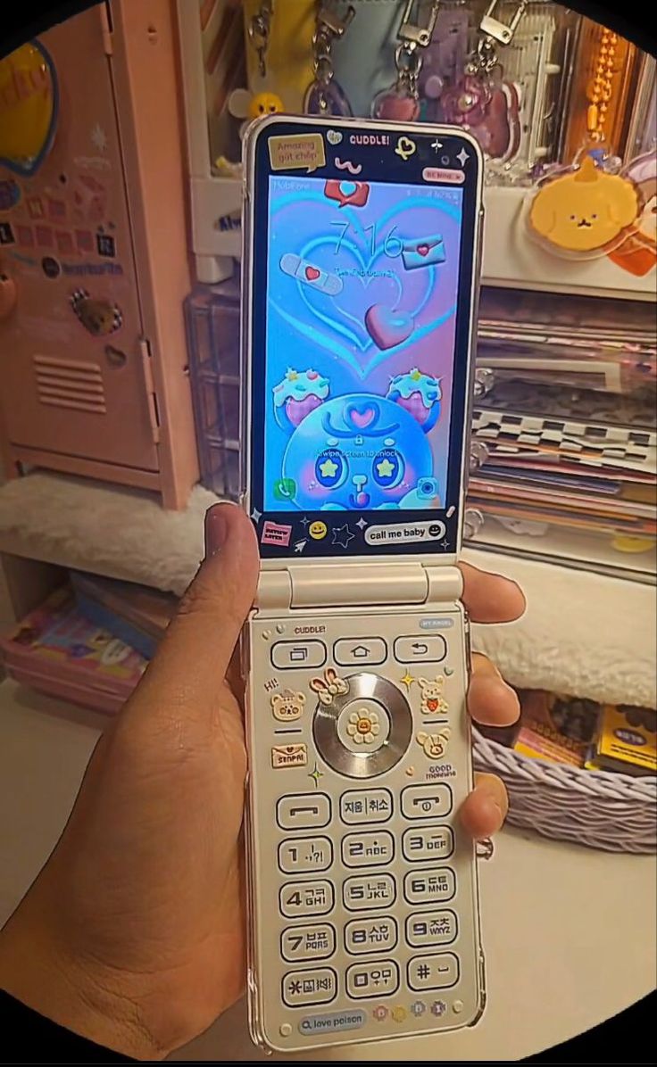 a person holding up a cell phone in their hand with an animated character on the screen