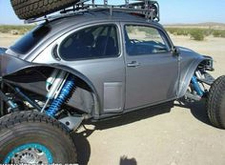 a gray buggy with some big tires on it