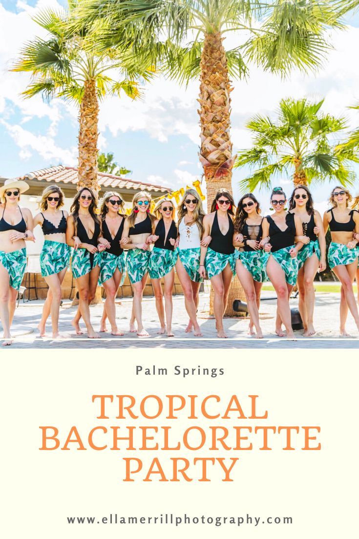 a group of women in bathing suits standing next to each other with palm trees behind them