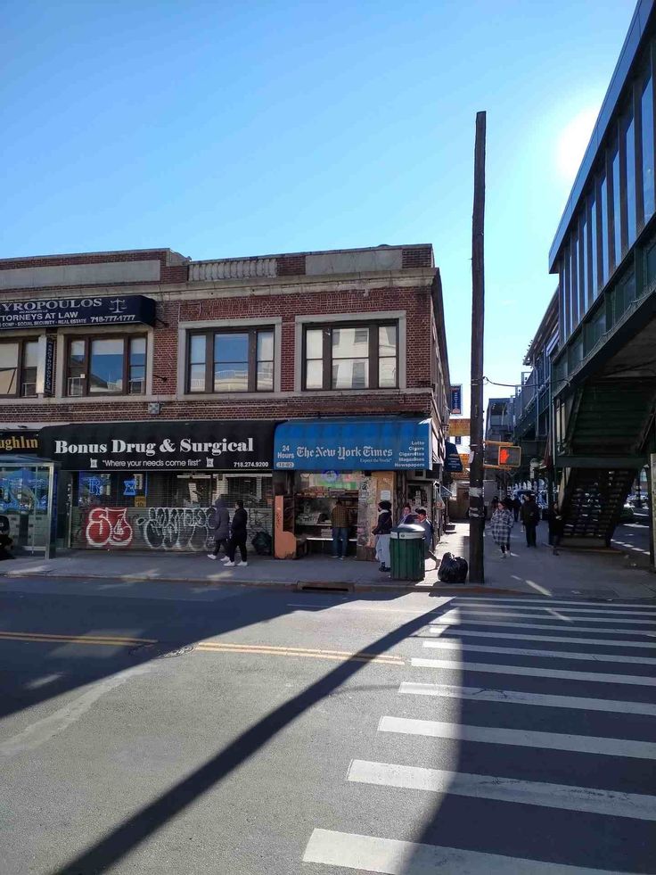 an empty street with people walking on the sidewalk