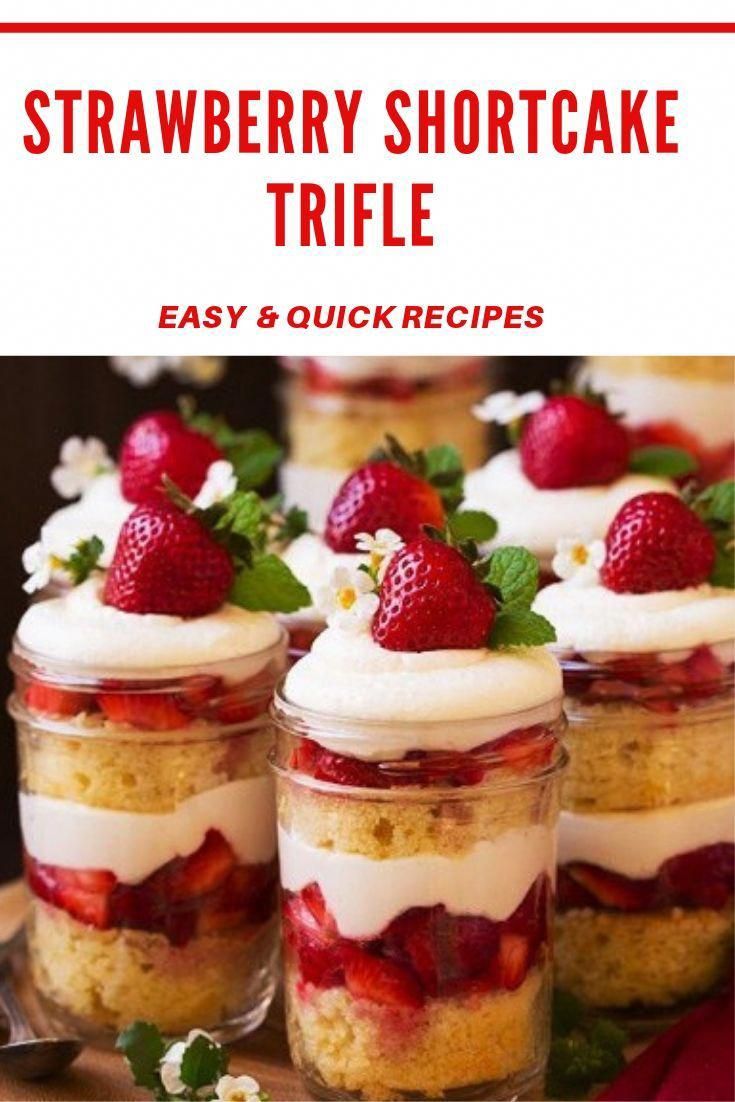 strawberry shortcakes with whipped cream and fresh strawberries in small jars on a wooden tray