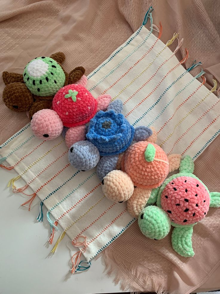 several crocheted fruits and vegetables are laying on a blanket