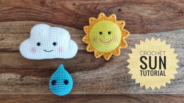 crochet sun, cloud and water drop on wooden background