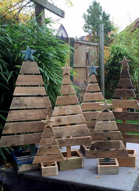 several wooden christmas trees sitting on top of a table