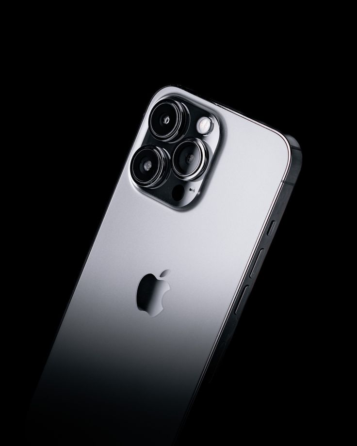 an iphone 11 camera is seen in this image taken from the back, on a black background