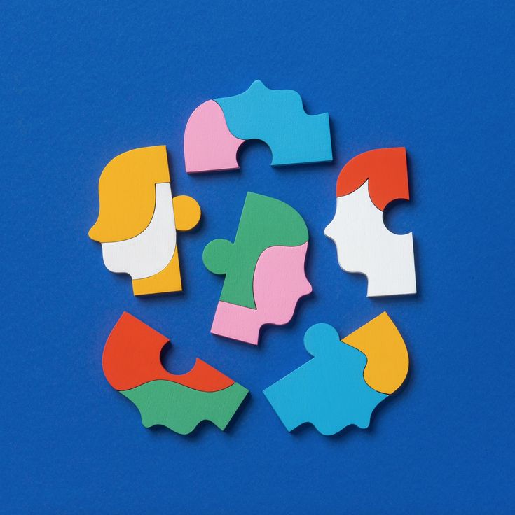 several pieces of colorful puzzle on a blue background