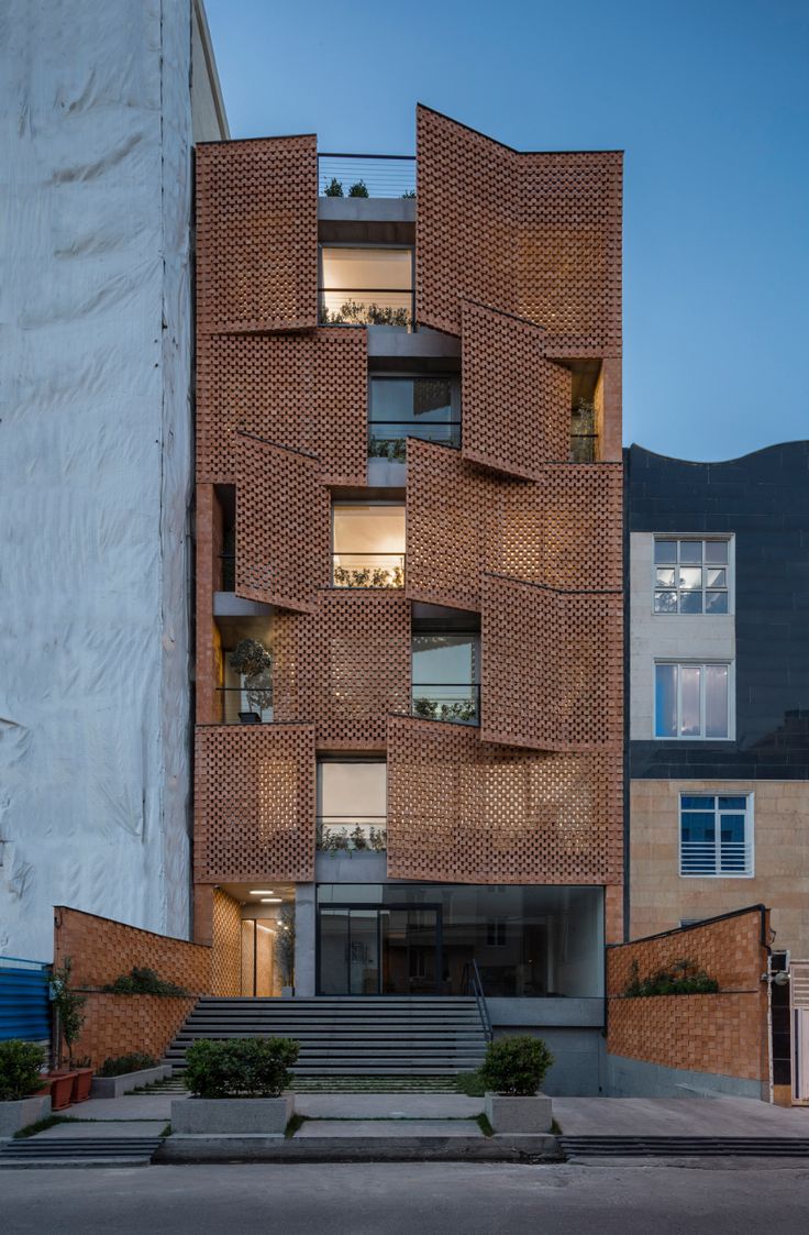 the building is made out of bricks and has stairs leading up to it's second floor