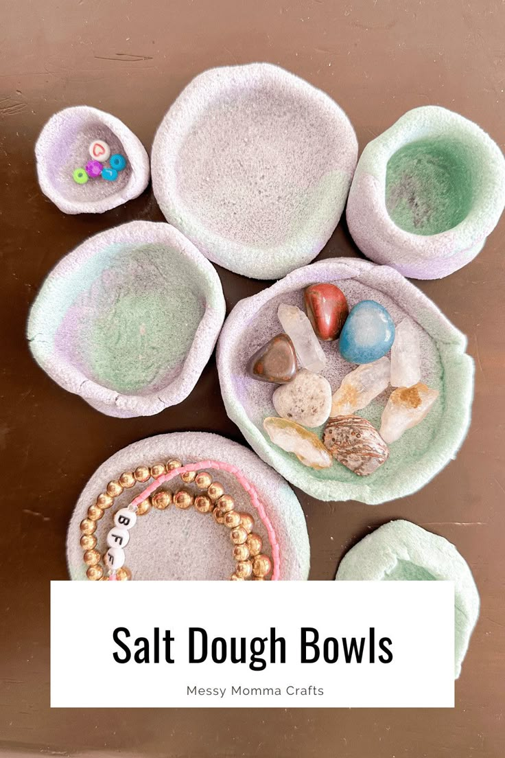 several bowls filled with different types of sea shells and beads on top of a wooden table