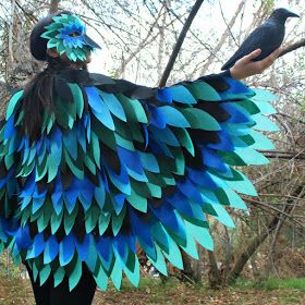 a woman wearing a blue and green bird costume