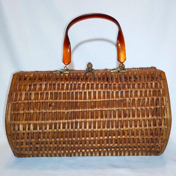 a brown wicker purse sitting on top of a white table