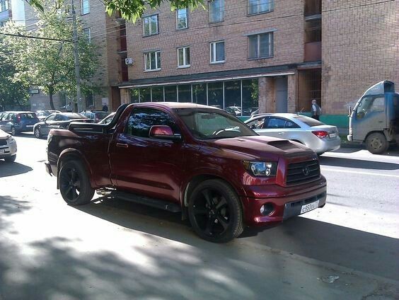 a red truck parked on the side of a street