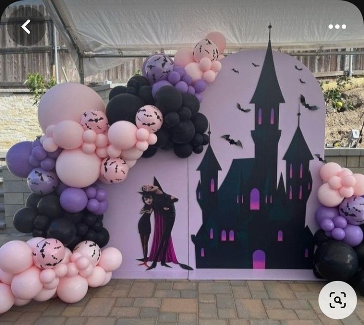 some balloons are on the ground near a castle