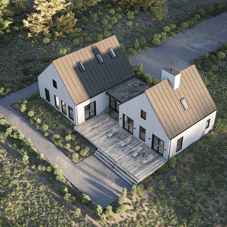 an aerial view of a two story house with metal roofing and brown shingles