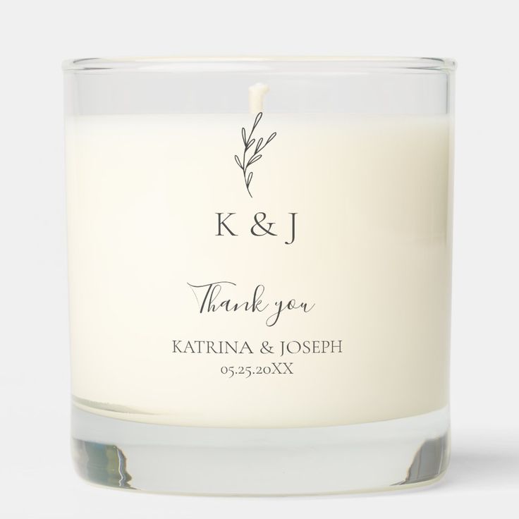 a white candle with the words k & j on it