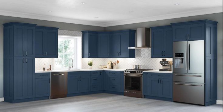 a large kitchen with blue cabinets and stainless steel appliances in the middle of the room