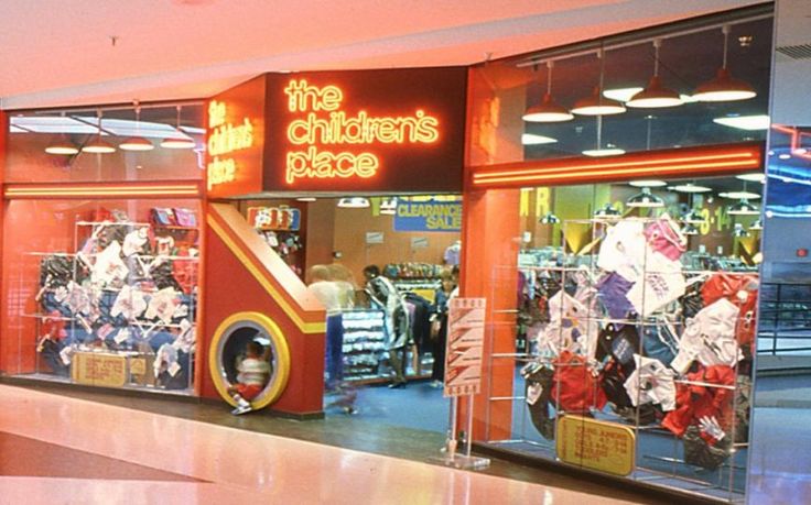 the children's place store is brightly lit and has an in - floor carousel