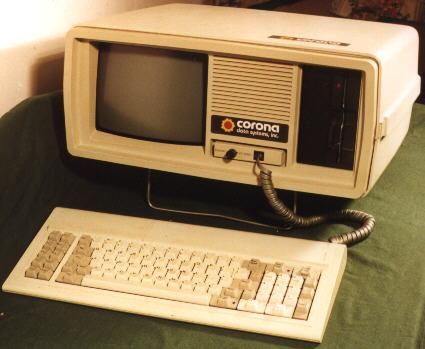 an old computer sitting on top of a green blanket next to a keyboard and mouse