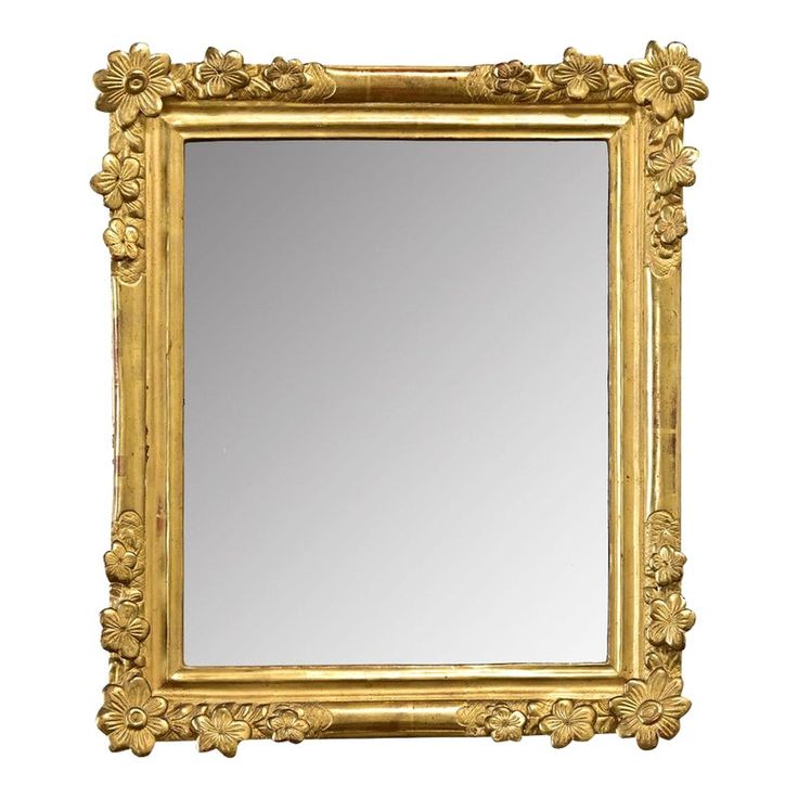 an ornate gold framed mirror against a white background