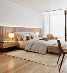 a large bed sitting next to a window in a bedroom on top of a hard wood floor