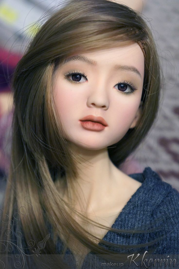 a close up of a doll with long hair