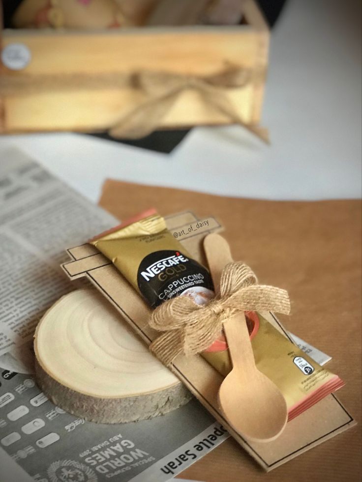 a wooden spoon sitting on top of a piece of paper next to a box with some kind of food in it