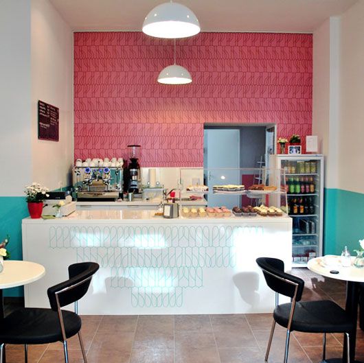 the interior of a restaurant with tables and chairs in front of an ice cream counter