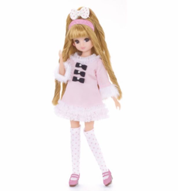 a doll with long blonde hair wearing a pink dress and white polka dot tights