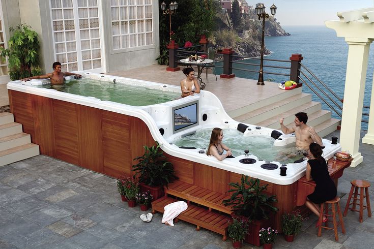 people are sitting in an outdoor hot tub