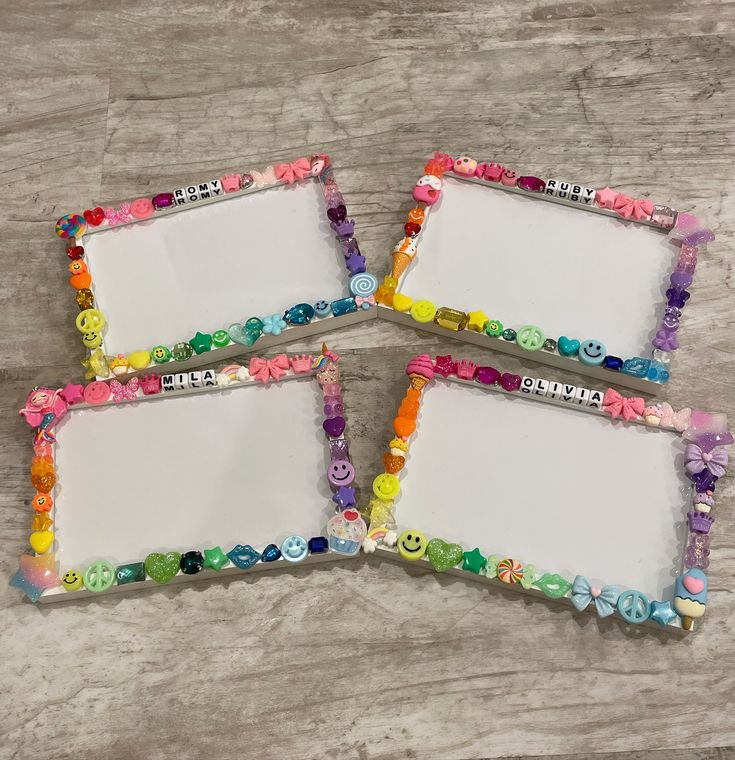 three colorful frames with buttons on them sitting on a table