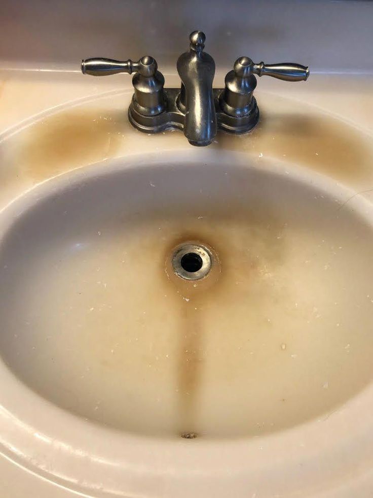 a sink that has some brown stains on it