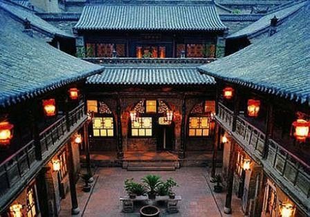 an outdoor courtyard with lanterns and potted plants