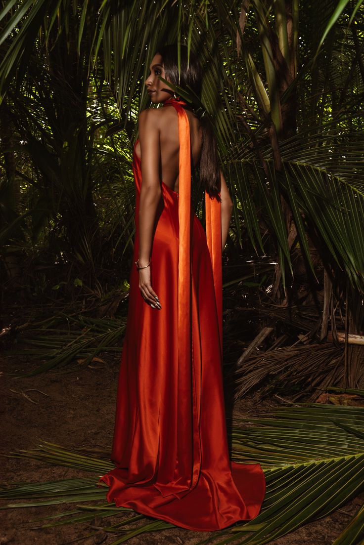 SAKAI DRESS | ORANGE HUE Crafted from luxurious exotic satin fabric, drapes gracefully, sculpting a silhouette that captivates with every step.Paired with this exquisite dress is a long and sophisticated scarf, meticulously crafted from the same opulent satin. The scarf adds an ethereal touch, flowing elegantly with movement and allowing you to indulge in a sense of heightened luxury. Kriado DesignFor information:San Juan: 787-400-5909Ponce: 787-244-3800 Model wearing size: 2 True to Size. Dry Clean Only Color might be different due to camera effect. US 2 measurements: Bust: 34" Waist: 26 1/2" Hips: 37" US 4 measurements: Bust: 35" Waist: 28 1/2" Hips: 40" US 6 measurements: Bust: 37" Waist: 30" Hips: 41" US 8 measurements: Bust: 38" Waist: 31 1/2" Hips: 42" Silk Dress Photoshoot Ideas, Warm Orange Aesthetic, Orange Fashion Aesthetic, Orange Bridesmaids Dress, Orange Photoshoot, Orange Wedding Dress, Orange Dress Wedding, Orange Silk Dress, Bridesmaid Stuff