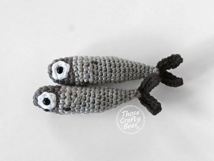 two crocheted stuffed animals with eyes on them