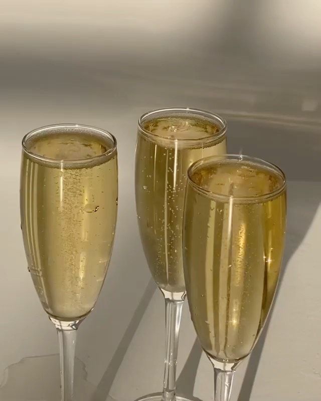 three champagne glasses sitting next to each other