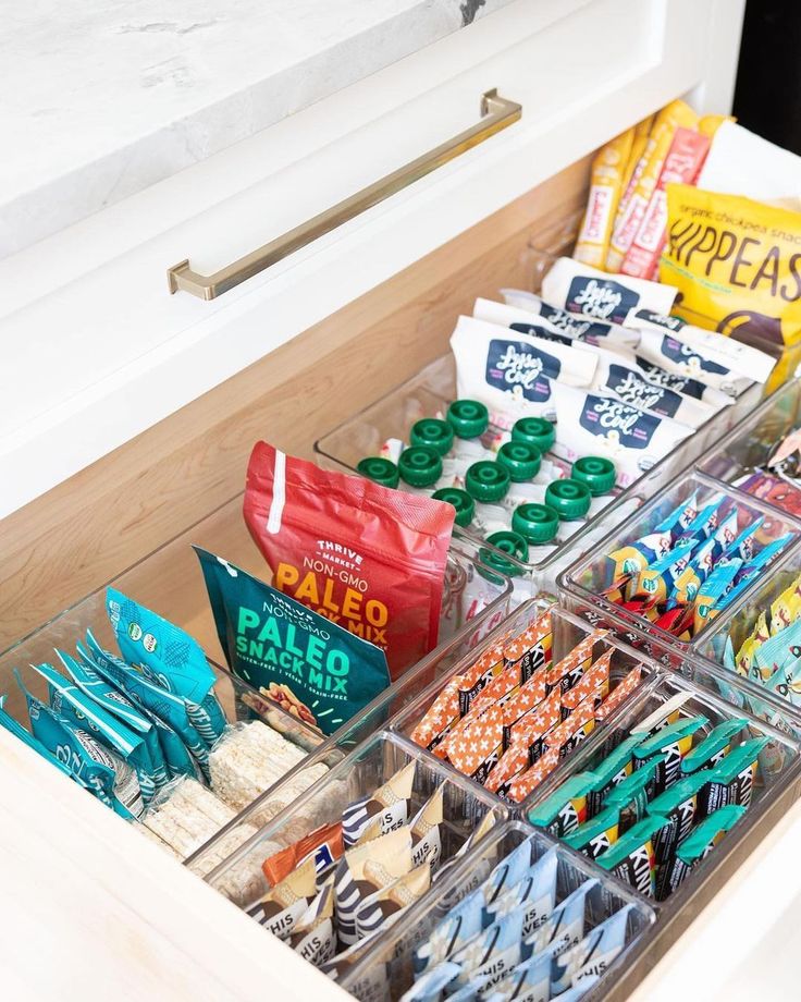 an organized drawer with snacks and candy