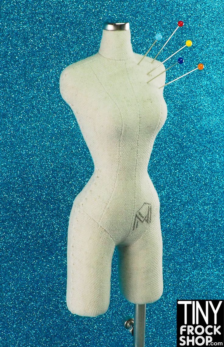 a white female mannequin with pins on it's head and legs in front of a blue background